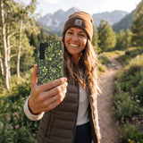 Black Evergreen Samsung Galaxy S25 Case - Lifestyle photo showing phone case in use