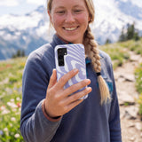 Lavender Flutter Left Samsung Galaxy S25 Case - Lifestyle photo showing phone case in use
