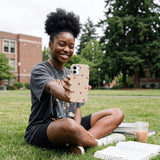 Seashell Lil Flutters iPhone 15 Case - Lifestyle photo showing phone case in use