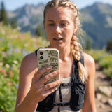 London Fog Jurassic iPhone 15 Pro Case - Lifestyle photo showing phone case in use