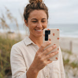 Seashell Lil Crabby Samsung Galaxy S25 Case - Lifestyle photo showing phone case in use