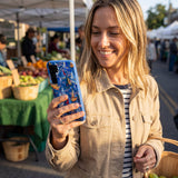 Electric Blue Dockside Dreams Samsung Galaxy S25 Case - Lifestyle photo showing phone case in use