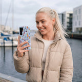 Powder Blue Sails and Seagulls Samsung Galaxy S25 Case - Lifestyle photo showing phone case in use