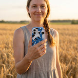 Electric Blue Cat Cow iPhone 15 Case - Lifestyle photo showing phone case in use
