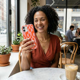 Bubblegum Pink Purr iPhone 14 Case - Lifestyle photo showing phone case in use