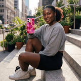 Bubblegum Pink Pink Orchids iPhone 15 Case - Lifestyle photo showing phone case in use