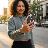 Black Ghost Stamps iPhone 15 Pro Case - Lifestyle photo showing phone case in use