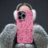Bubblegum Pink Festive Forest iPhone 16 Case - Lifestyle photo showing phone case in use