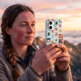 Powder Blue Noel Stamps iPhone 16 Pro Case - Lifestyle photo showing phone case in use