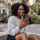 Black Jaguar Stars Samsung Galaxy S25 Case - Lifestyle photo showing phone case in use