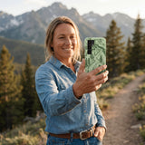 Sage Green Into the Mountains MTBCO Samsung Galaxy S25 Case - Lifestyle photo showing phone case in use