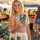 Electric Blue Pickling Pickles iPhone 15 Case - Lifestyle photo showing phone case in use