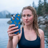 Electric Blue Fancy Frogs iPhone 14 Case - Lifestyle photo showing phone case in use