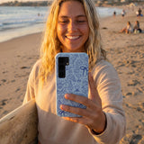 Powder Blue Ocean Charms Samsung Galaxy S25 Case - Lifestyle photo showing phone case in use