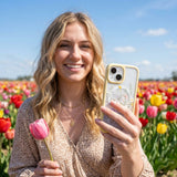 Clear Wanderflora iPhone 17 Case With Sunbeam Ridge (MagSafe included) - Lifestyle photo showing phone case in use