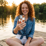 Clear Tiger Lily iPhone 17 Case With Noir Ridge (MagSafe included) - Lifestyle photo showing phone case in use