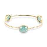 Our Sasha Gold Bangle With Amazonite Gemstones is handmade with recycled materials for minimal environmental impact. Adorned with three stunning vintage Amazonite gemstones, this bangle catches the light with your every move.