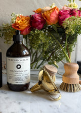 Heirloom Dish Soap lifestyle shot with ceramic tray and natural cleaning tools for eco-friendly kitchen