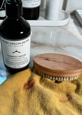 Natural bristle laundry brush for pre-treating fabric stains with Murchison-Hume laundry products