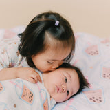 sister kissing baby on boba minky blanket