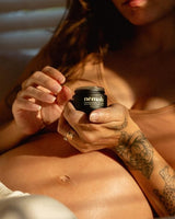 pregnant lady is applying a cream on her belly