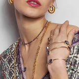 A simple and elegant everyday bangle with three faceted oval shaped lolite gemstones. This handmade and sustainable gold bangle only enhances the gorgeous purple and lilac tones of the natural gemstones. This bangle does not have a clasp and slips over your wrist. Sustainable materials are 14 Carat gold vermeil