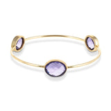 Our Sasha Gold Bangle With Lolite Gemstones is handmade with recycled materials for minimal environmental impact. Adorned with three stunning vintage lolite gemstones, this bangle catches the light with your every move.