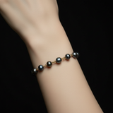 Close-up of model wearing Gold Stainless Steel Linked Black Pearl Bracelet - Square