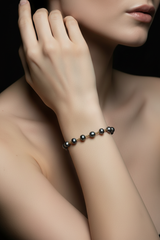 Close-up of model wearing Gold Stainless Steel Linked Black Pearl Bracelet
