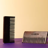 Two combs, both brown, on a purple surface with a beige background.