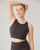 Model wearing the L’Original bra in Java brown color, made from OEKO-TEX® certified compression fabric with Elastique’s MicroPerle® technology to enhance circulation, support lymphatic drainage, and provide pain relief.