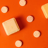shower steamers with heart-shaped decorations on an orange background