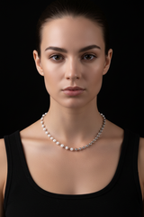 Split White Pearl Necklace on black background