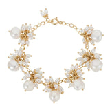 The Venus white pearl dangle gold chain bracelet is handmade in our studio with sustainable materials. The gold chain really enhances the colour of the natural glossiness of the white baroque pearls all wire wrapped into little dangles around the chain.