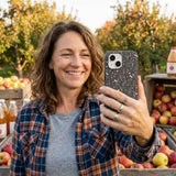 Black Night Garden iPhone 14 Case - Lifestyle photo showing phone case in use