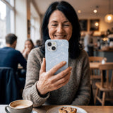 Powder Blue Snowy Mountains iPhone 14 Case - Lifestyle photo showing phone case in use