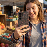 Black Night Garden Samsung Galaxy S25 Case - Lifestyle photo showing phone case in use