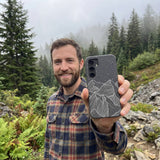 Black Night Panorama Samsung Galaxy S25 Case - Lifestyle photo showing phone case in use