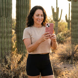 Bubblegum Pink Flora iPhone 14 Case - Lifestyle photo showing phone case in use