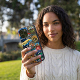 Black Trail Stickers iPhone 15 Case - Lifestyle photo showing phone case in use
