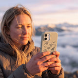 London Fog Dinosaurology iPhone 15 Case - Lifestyle photo showing phone case in use