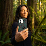 Black Fossilized iPhone 15 Case - Lifestyle photo showing phone case in use