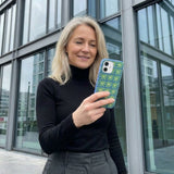 Electric Blue Flower Child iPhone 14 Case - Lifestyle photo showing phone case in use