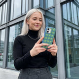 Electric Blue Flower Child iPhone 15 Pro Case - Lifestyle photo showing phone case in use