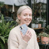 Powder Blue Sweet Cherries iPhone 15 Pro Case - Lifestyle photo showing phone case in use