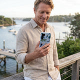 Powder Blue Tropical Rainforest Samsung Galaxy S25 Case - Lifestyle photo showing phone case in use