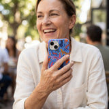 Electric Blue Jungle Cat iPhone 14 Case - Lifestyle photo showing phone case in use