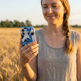 Electric Blue Cat Cow iPhone 14 Case - Lifestyle photo showing phone case in use