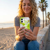 Sage Green Orchid Blooms iPhone 15 Case - Lifestyle photo showing phone case in use