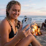 Powder Blue Camp Nights iPhone 15 Case - Lifestyle photo showing phone case in use